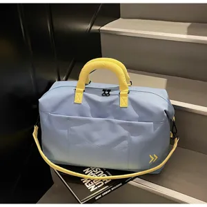 Large capacity travel duffel bag with contrast yellow handles for weekend trips and sport.
