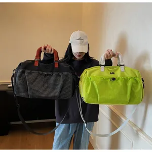 Large capacity travel duffel bag with grid pocket and shoulder strap for sports and gym use.