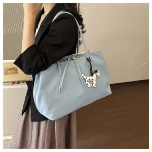 Light blue large capacity tote bag with cute puppy charm, stylish commuting shoulder bag.