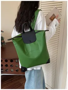 Zaino da commuter in nylon con patta in pelle e manico verde brillante per uso quotidiano.