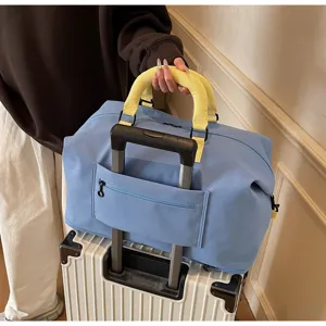 Large capacity blue travel duffel bag with yellow handles, perfect for weekend trips and gym sports.