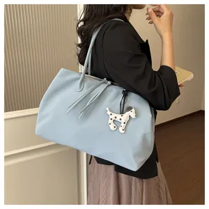 Light blue large capacity tote bag with cute dog charm, stylish shoulder bag for daily commute.