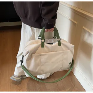 Detailed shot of large capacity travel duffel bag with green handles in daily use scene.