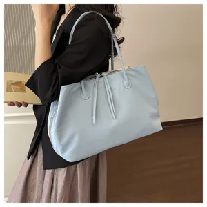 Light blue tote bag detail view showcasing large capacity and fine strap craftsmanship.