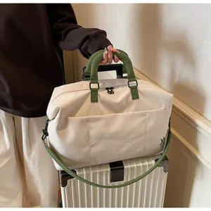 Large capacity travel duffel bag, weekend overnight bag with green handles and adjustable strap.