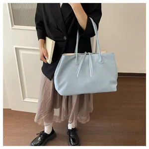 Light blue casual tote bag detail showing large capacity design and minimalist style for daily use.