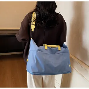 Detailed view of large capacity travel duffel bag with stylish contrast straps and compartments.