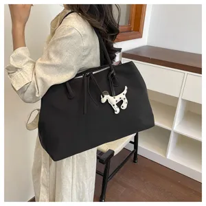 Black canvas tote bag with cute dog pendant, large capacity shoulder bag for daily commute.