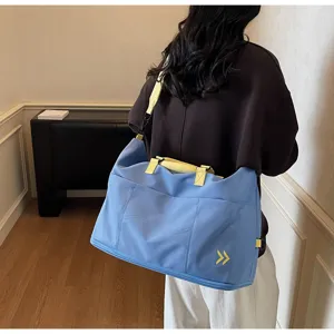 Large capacity travel duffel bag for women, stylish shoulder gym bag with durable straps.