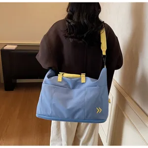 Detail view of large capacity travel duffel bag with yellow straps for gym and trips.