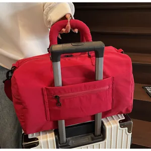 Large capacity red travel duffel bag lightweight gym handbag with trolley sleeve for women.