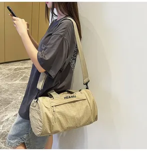 Khaki sports duffel bag with adjustable strap and handle for gym and travel.