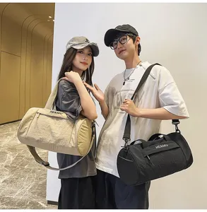 Detail view of large capacity cylindrical gym duffel bag, travel shoulder bag for men and women.