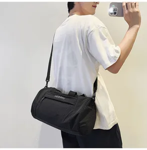 Black cylindrical sports duffel bag for men and women, perfect for gym, travel, and yoga.