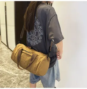 Casual khaki sports duffel bag for travel and fitness with shoulder strap and large capacity.