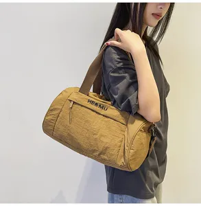 Small cylindrical sports gym bag and travel duffel bag for women and men daily use