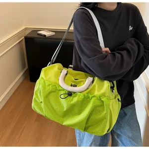 Neon green travel duffel bag detail, large capacity gym sports bag with front pocket.