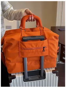 Large capacity travel duffel bag for short trips, portable luggage bag with trolley sleeve.