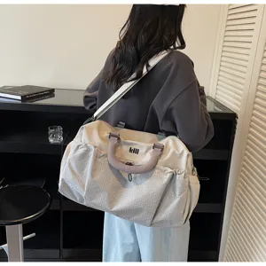 Large capacity travel duffel bag for women, shoulder fitness bag and weekend luggage design.