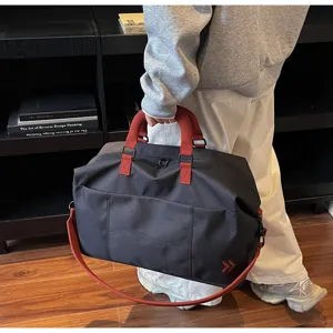 Large capacity travel duffel bag, casual black gym bag with red straps for weekend trips.