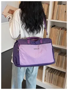 Vue détaillée du grand sac de voyage avec poche à carreaux et bretelles confortables.