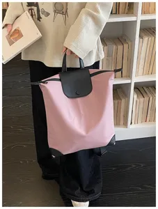 Zaino da lavoro rosa minimalista con patta in pelle nera e grande capacità di carico.