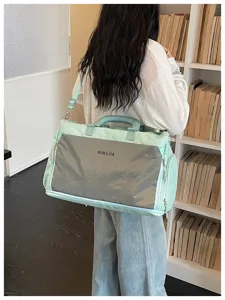 Vue détaillée du grand sac de voyage montrant la sangle, la fermeture éclair et la poche.