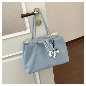 Light blue canvas tote bag detail view, large capacity shoulder commuting bag with cute puppy charm.