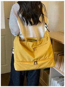 Detailed back view of a large capacity yellow travel duffel bag for gym, sports and short trips.