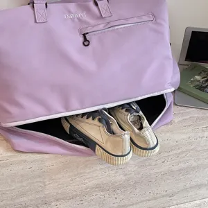 Large capacity purple travel duffel bag with bottom shoe compartment for gym and fitness sports.