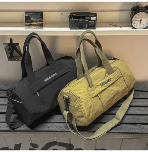 Cylindrical sports duffel bag for gym, travel, and yoga with shoulder strap and large capacity.