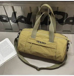 Olive green canvas travel duffel bag with shoulder strap and front pocket storage.