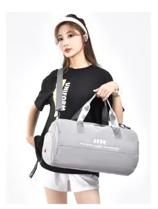 Light grey gym duffel bag for sports and travel with large capacity and comfortable strap.