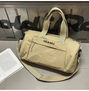 Khaki canvas gym duffel bag with shoulder strap, front pocket and durable handles for travel.