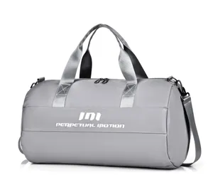 Grey gym duffel bag detail showing durable handles, adjustable shoulder strap, and fabric.