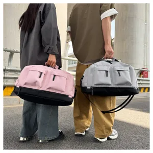 Outdoor lifestyle detail view showing large capacity duffel sports travel bag in pink and grey.