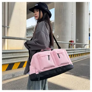 Detailed lifestyle view of a large capacity pink travel duffel bag with dry wet separation.