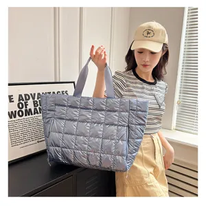 Stylish metallic blue quilted puffer tote bag, perfect for yoga, gym, and travel use.