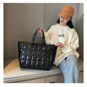 Black quilted puffer tote bag for women, stylish down cotton shoulder travel fitness bag detail.