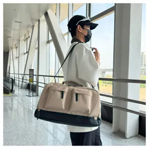Large capacity travel duffel bag with separate shoe compartment and multiple front utility pockets.