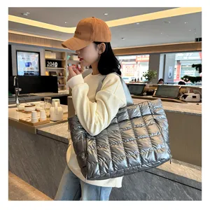 Silver quilted puffer tote bag detail, stylish metallic shoulder bag for daily travel and commute.
