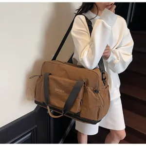 Detailansicht der großen braunen Reisetasche mit praktischem Taschenlayout und Griffen.