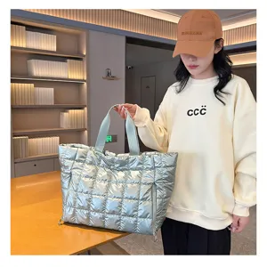 Detailed view of the stylish silver quilted puffer tote bag, showing texture and large capacity.