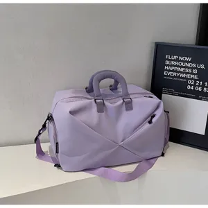Light purple travel duffel bag detail, large capacity gym bag with sturdy handles and strap.