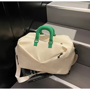 Large capacity travel duffel bag in beige with green handles, ideal for sports and fitness gym use.
