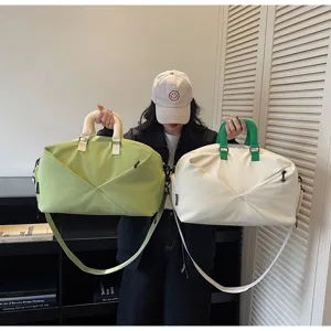 Large capacity travel duffel bag for gym, sports, and weekend trips with crossbody strap.