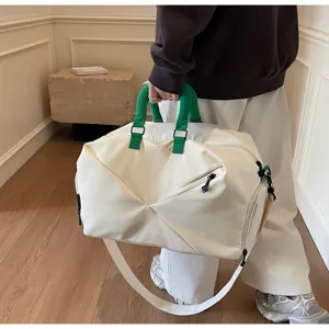 Large capacity travel duffel bag for gym, fitness, and sports, with canvas fabric and shoulder strap.