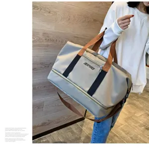 Oxford cloth travel duffel bag detail showcasing sturdy handles and large storage space.