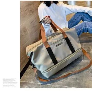 Detail view of large capacity oxford travel duffel bag in light gray for women and gym.