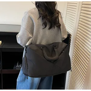 Large capacity travel duffel bag for gym and sports, waterproof black shoulder handbag.